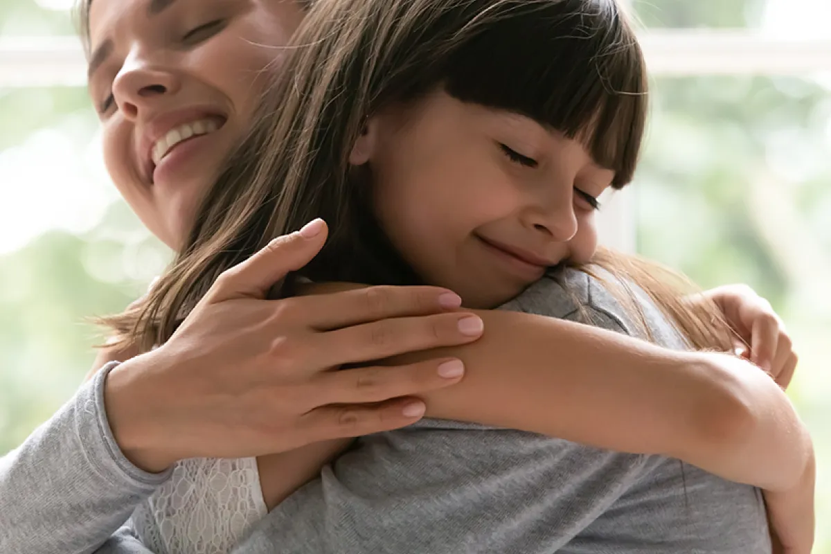 Image of child and parent embracing