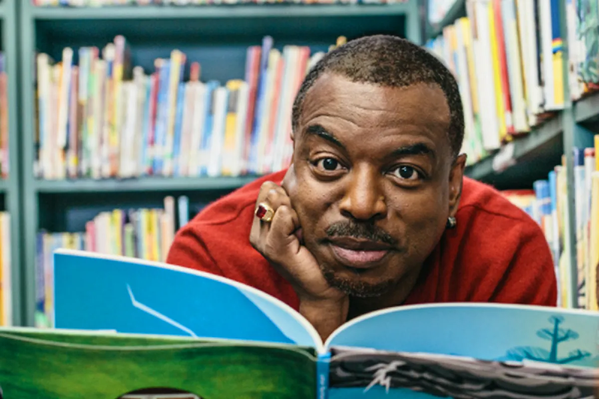 Image of LeVar Burton reading a book