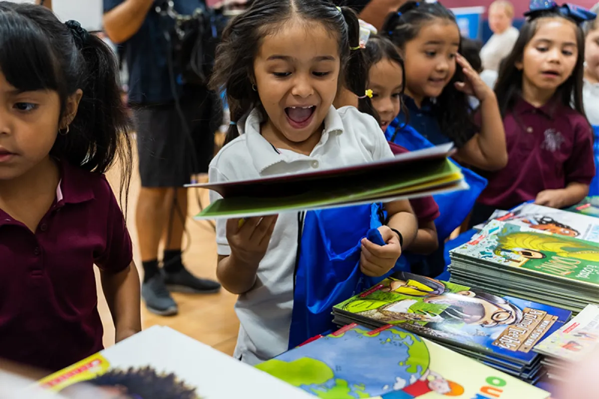 Image of girl happily holding a book