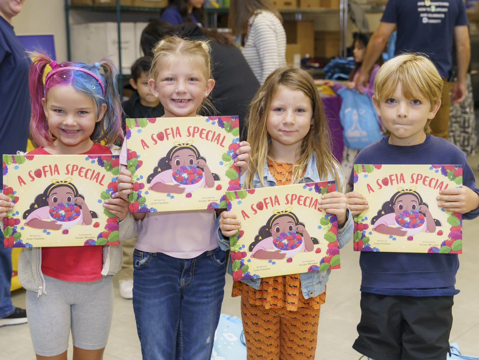 Children posing with books