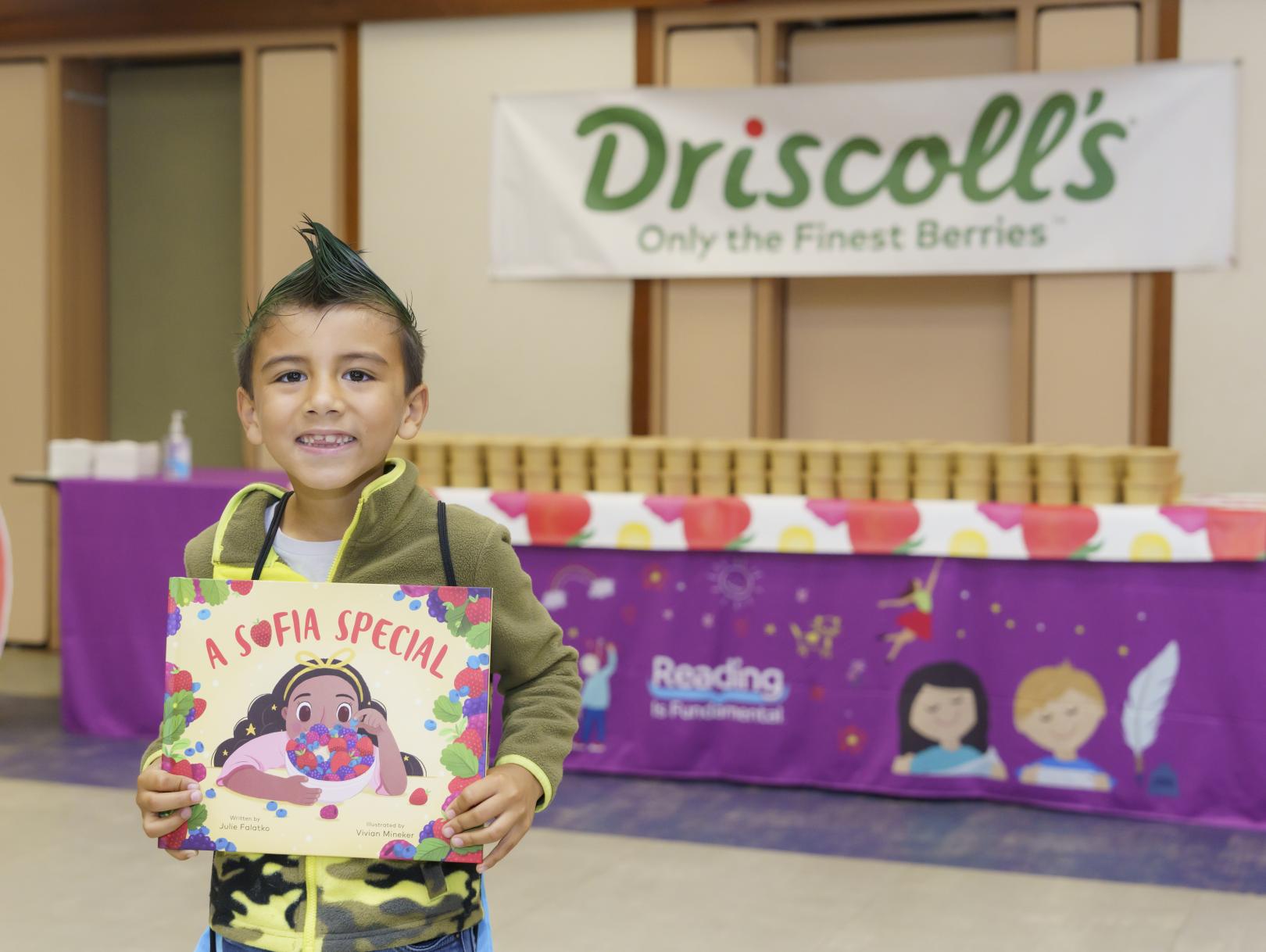 Boy smiling with book