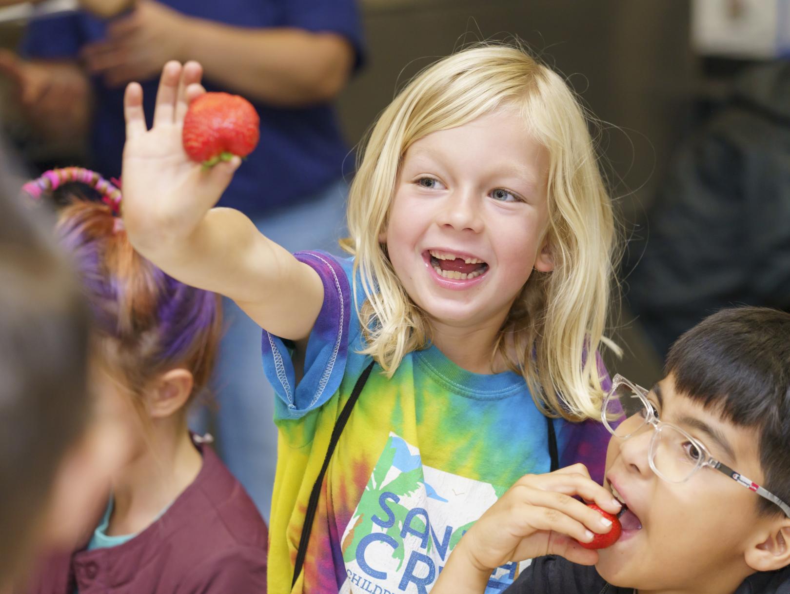 Girl showing off strawberry