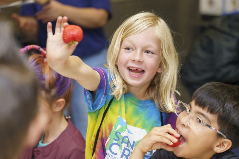 Girl showing off strawberry